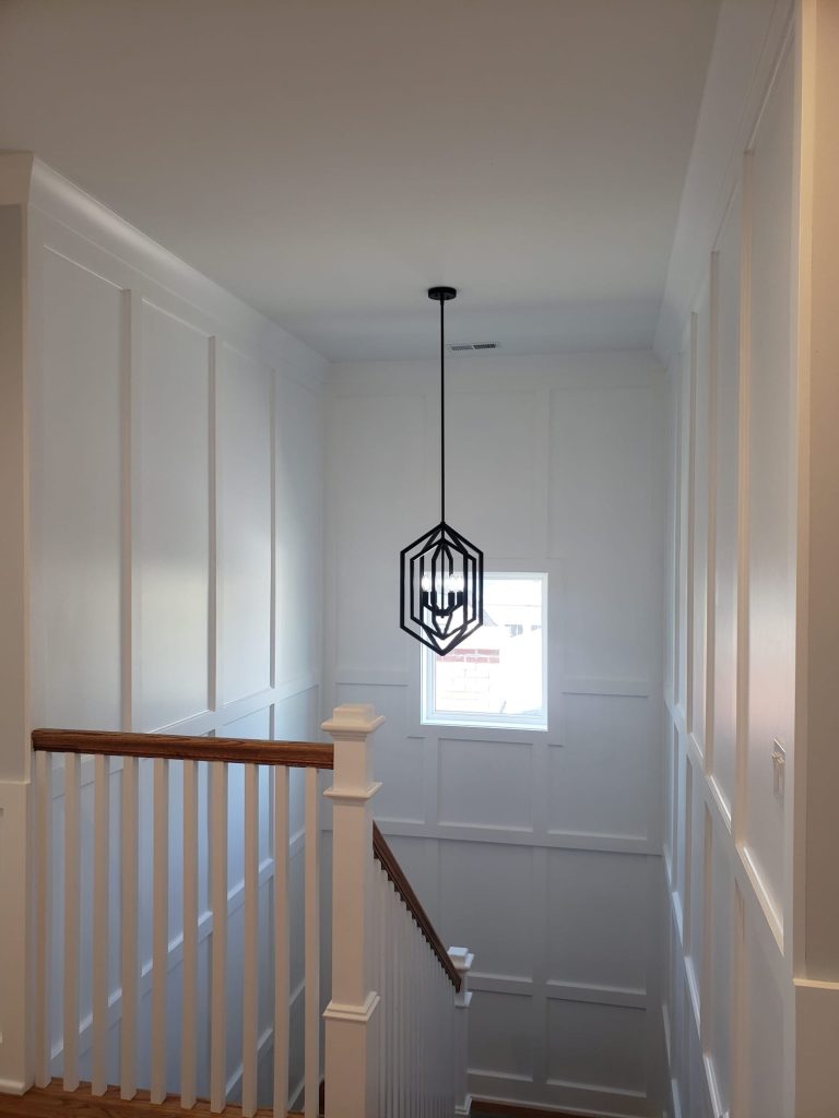 Full-height wainscoting paneling and staircase — Chicago residence