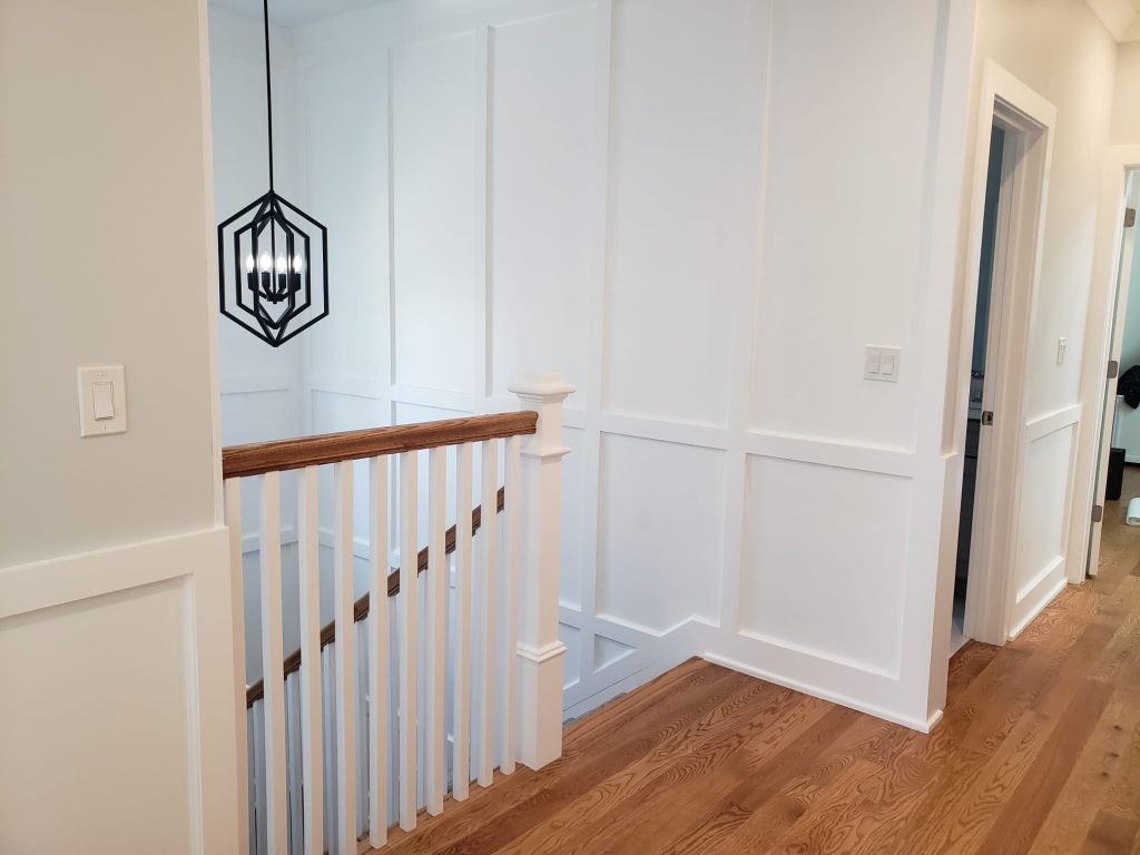 Full-height wainscoting paneling and staircase — Chicago residence
